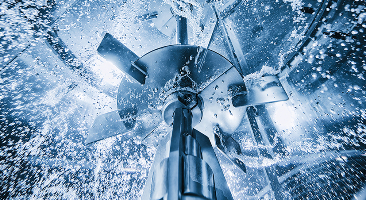 Large rushton impeller in motion in large tank with water
