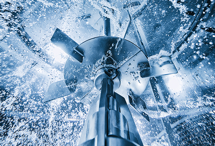 Large rushton impeller in motion in large tank with water
