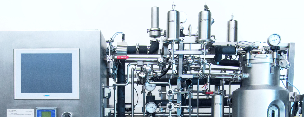 The image shows a laboratory with a large stainless steel bioreactor labeled 
