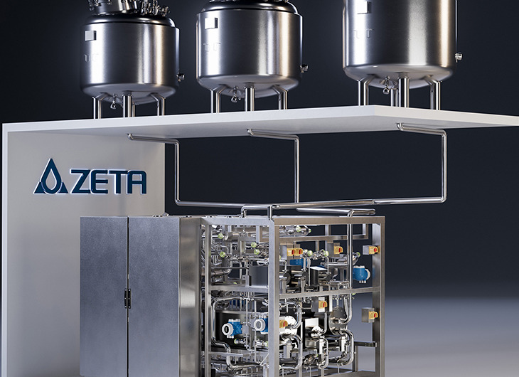 The image shows three large stainless steel tanks on a platform, connected by a network of pipes and valves. It’s part of a clean, high-tech industrial system, likely used in pharmaceutical, chemical, or food production. The brand “ZETA” is visible on the left side.