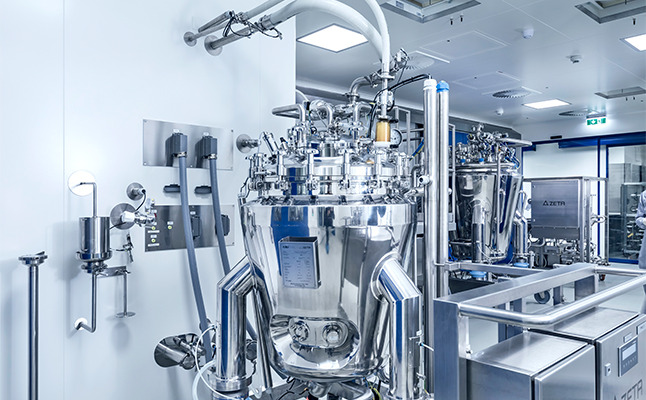Mobile skid in production area docked with tubings to the docking station on the wall