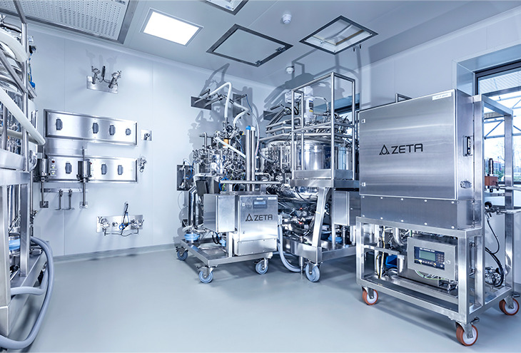 Mobile production skids in cleanroom area, docked on their docking stations on the wall